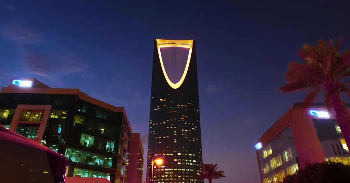 The illuminated Kingdom Centre tower rising over the Riyadh skyline at twilight, capital of Saudi Arabia