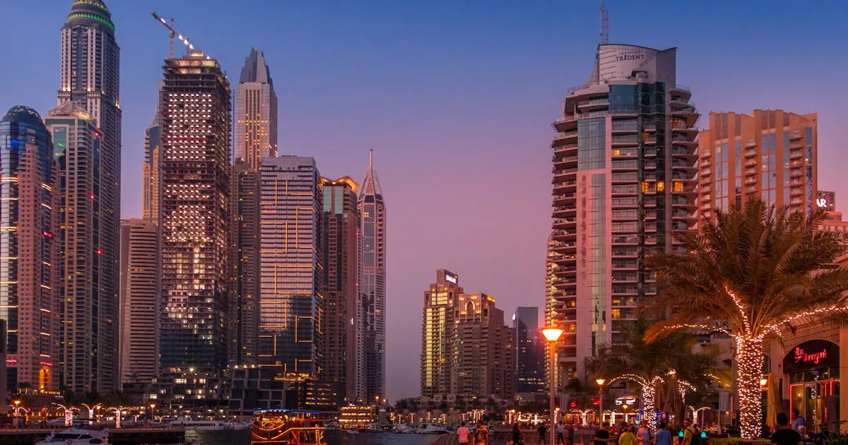 Dubai skyline at dusk with Burj Khalifa and Sheikh Zayed Road, viewed from across the city