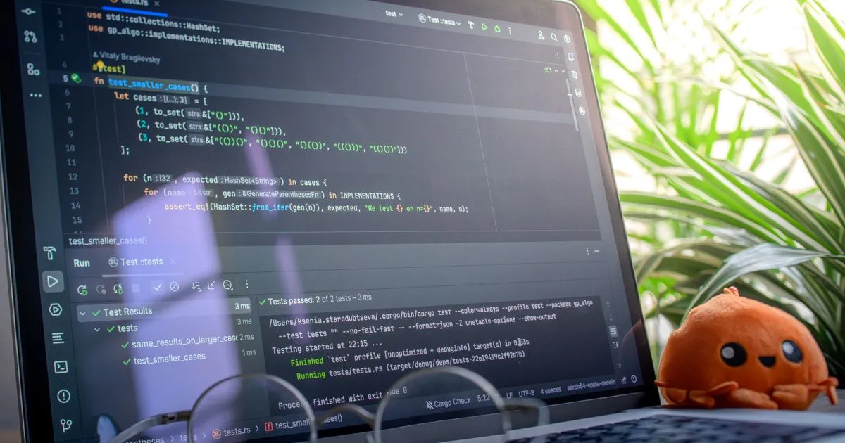 Open laptop displaying code, QA engineer test review